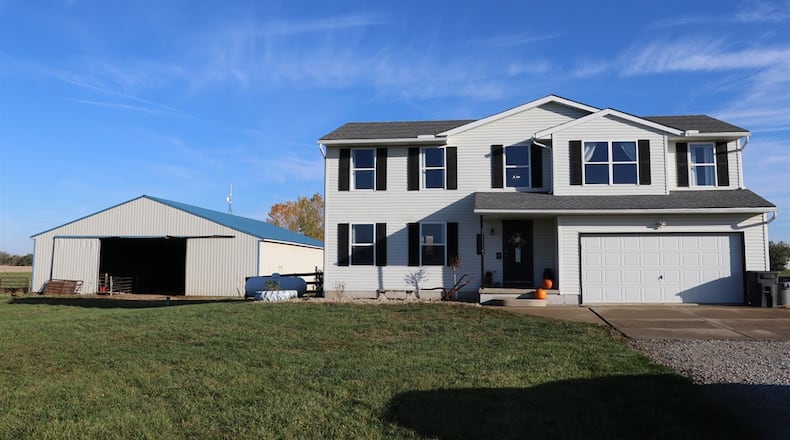 Listed for $558,950 by Berkshire Hathaway Home Services Professional Realty, the 10-acre property at 3095 E. Peterson Road in Lost Creek Twp. includes the fenced pasture, stocked pond, two pole barns, an above-ground swimming pool and a two-story house with an attached two-car garage. A gravel drive leads up from the roadway to the concrete parking near the garage as the house sits well off the road. The stalled barn with dirt floor has fencing for small livestock. CONTRIBUTED