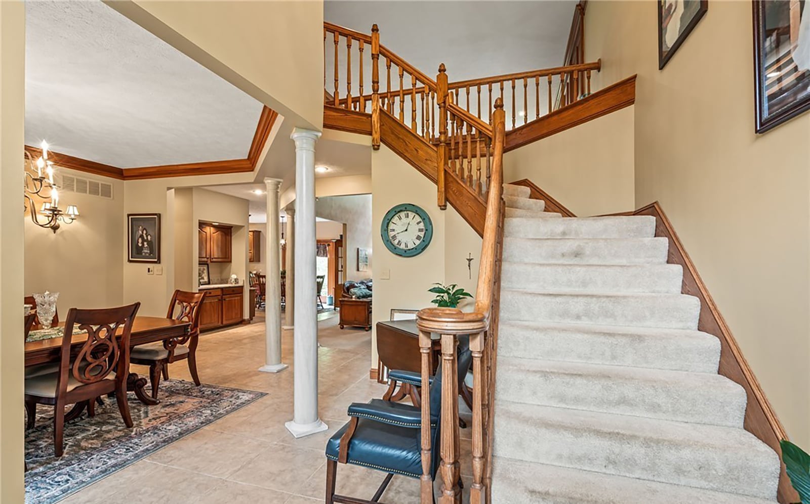 The home has an open floor plan on the first level with a formal dining room off the entry, tile flooring and a carpeted staircase leading to the second level.
