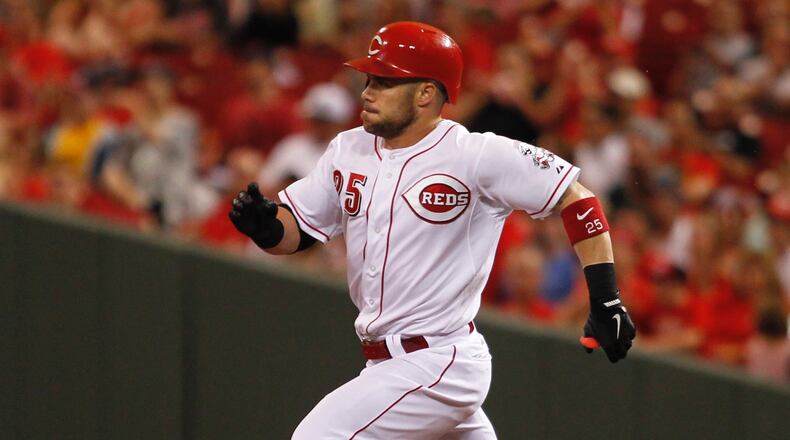 The Reds' Skip Schumaker heads to second with a double in the fifth inning Monday, July 7, 2014, at Great American Ball Park in Cincinnati.
