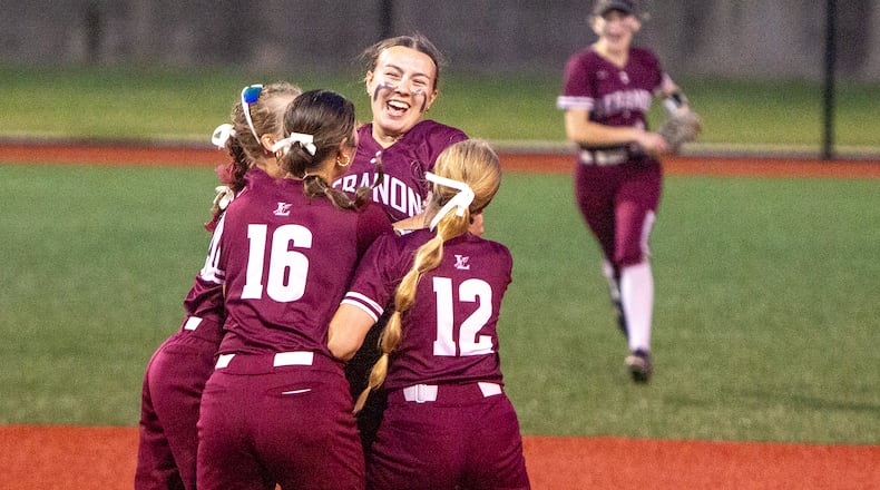 Lebanon pitcher Sophia Sheidler is surrounded by teammates after striking out the final batter in the Warriors' 3-1 victory over Centerville to win the Division I state championship at Firestone Stadium. Jeff Gilbert/CONRIBUTED