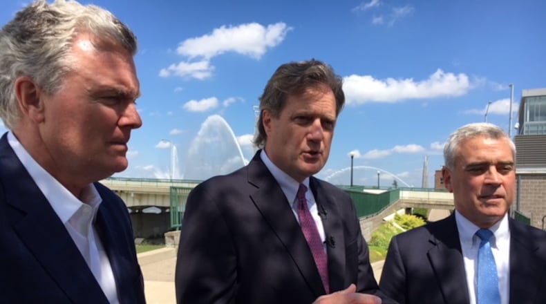 From left, residential developer Charlie Simms, U.S. Rep. Mike Turner (R-Dayton) and U.S. Rep. Brad Wenstrup (R-Cincinnati) at RiverScape Metro Park Wednesday. THOMAS GNAU/STAFF