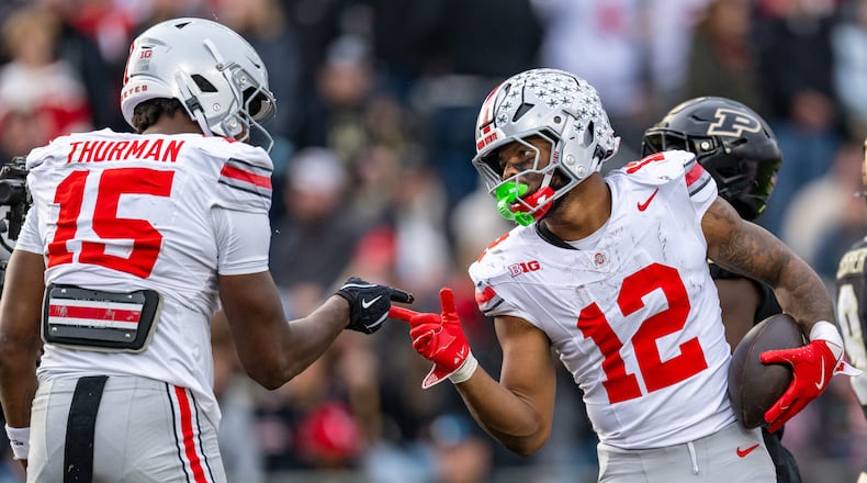 Ohio State running back CJ Donaldson Jr. (12) celebrates with tight end Jelani Thurman (15) after scoring during the second half of an NCAA college football game against Purdue, Saturday, Nov. 8, 2025, in West Lafayette, Ind. (AP Photo/Doug McSchooler)