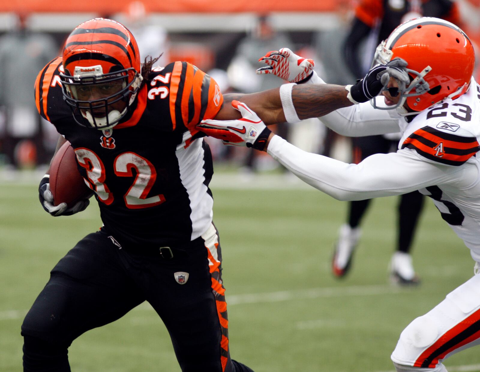  Cincinnati Bengals running back Cedric Benson (32) pushes off Cleveland Browns cornerback Joe Haden (23) in the second half of an NFL football game, Sunday, Dec. 19, 2010, in Cincinnati. Benson ran for 150 yards in the game won by Cincinnati 19-17. (AP Photo/David Kohl)