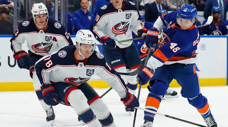 New York Islanders defenseman Matthew Schaefer (48) shoots the puck against Columbus Blue Jackets defenseman Damon Severson (78) during the second period of an NHL hockey game, Sunday, Nov. 2, 2025, in New York. (AP Photo/Noah K. Murray)