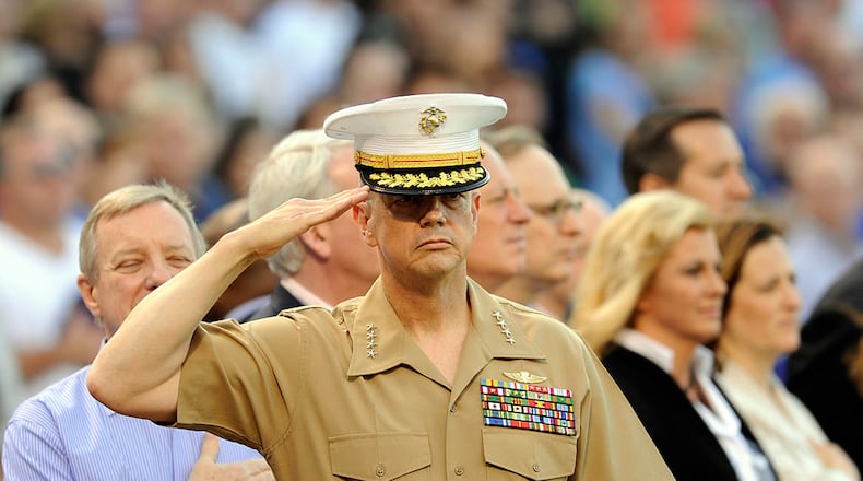 CHICAGO, IL - MAY 19: General John R. Allen, USMC-Commander, International Security Assistance Force salutes during the national anthem before the game between the Chicago Cubs and the Chicago White Sox on May 19 2012 at Wrigley Field in Chicago, Illinois. (Photo by David Banks/Getty Images)