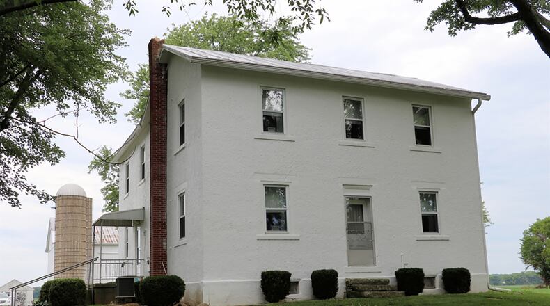 Built in 1845, the stucco-and-brick house sits well off the roadway with mature trees and stone-trimmed garden pads. A gravel drive leads to the surrounding 2.4 acres that include several out-buildings. CONTRIBUTED PHOTO BY KATHY TYLER