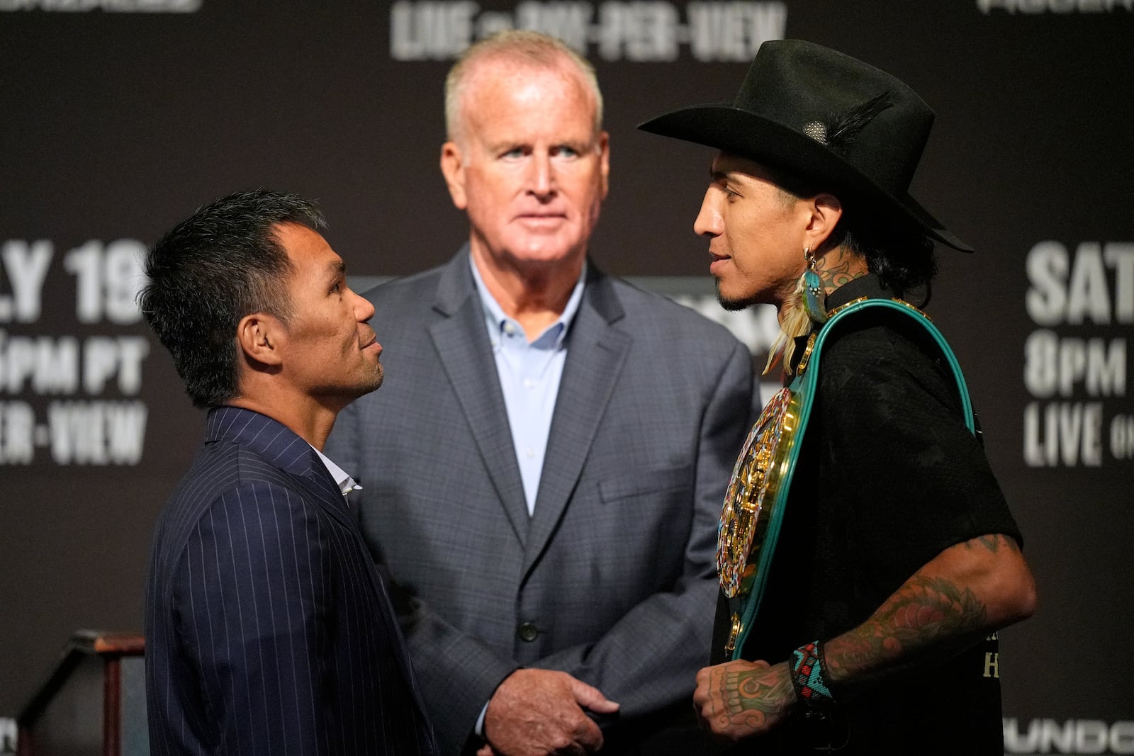 Manny Pacquiao, left, and WBC welterweight champion Mario Barrios pose at a news conference Wednesday, July 16, 2025, in Las Vegas. (AP Photo/John Locher)