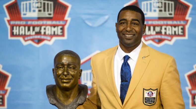 CANTON, OH - AUGUST 3: Former receiver Cris Carter of the Minnesota Vikings poses with his bust during the NFL Class of 2013 Enshrinement Ceremony at Fawcett Stadium on Aug. 3, 2013 in Canton, Ohio. (Photo by Jason Miller/Getty Images)