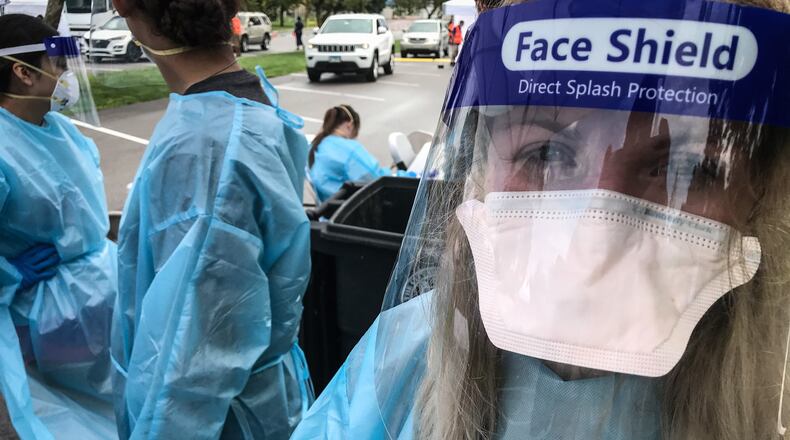 Jennifer Lowe, a member of the Ohio National Guard out of Mansfield Ohio, performs COVID-19 test at a Pop-Up COVID-19 Testing spot at Kettering Fields in Dayton Tuesday August 18, 2020.