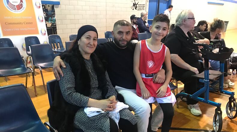 Turkish boxer Aydin Idrisov sits with his mom, Shura, and his dad, Ismail, after his bout on Sunday. Tom Archdeacon/CONTRIBUTED