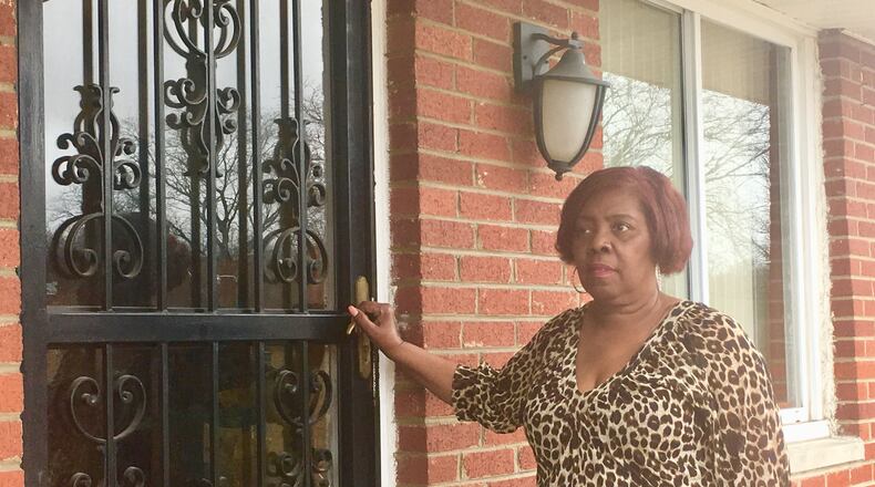 Wanda Dean stands on the porch of her Parkwood Drive home, Wednesday, Feb. 21, 2018. She’s frustrated with a low appraisal value her duplex received as she’s tried to sell it. Her neighborhood is one that data shows suffers from modern-day redlining. KATIE WEDELL/STAFF