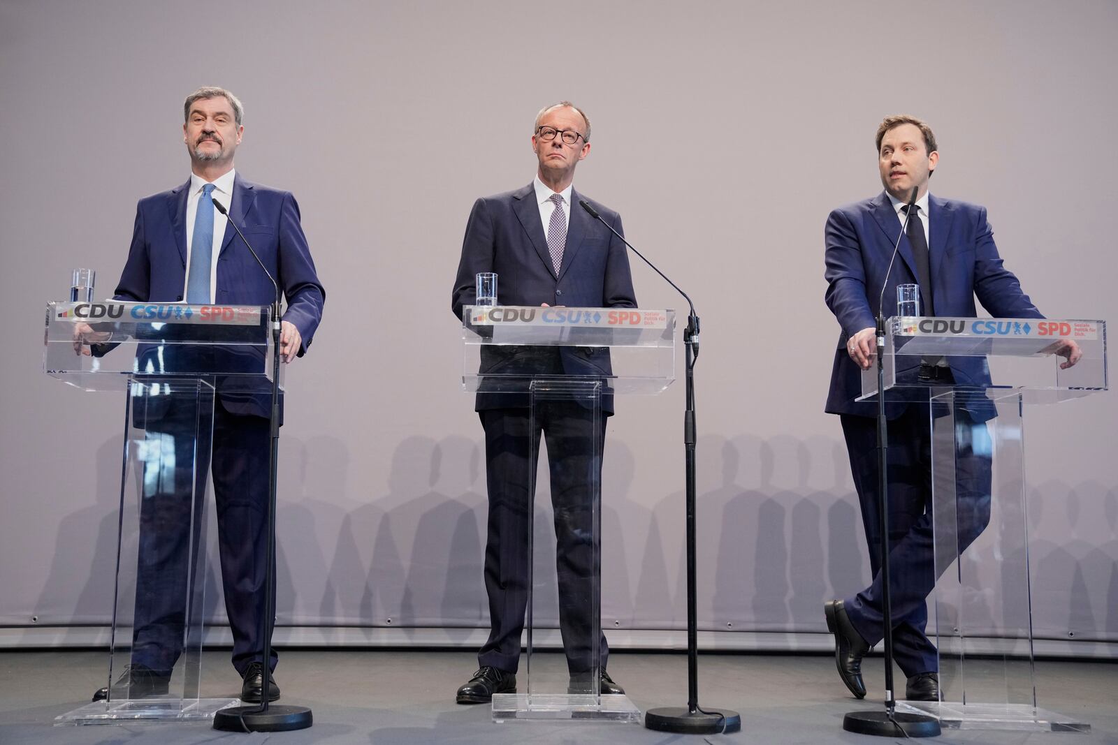Markus Soeder, chairman of Bavarian's Christian Social Union party, Friedrich Merz, Christian Democratic Union party chairman and the Social Democratic Party co-leaders Lars Klingbeil, address the media after reaching an agreement between their parties on a coalition for a new German government at a news conference in Berlin, Germany, Wednesday, April 9, 2025. (AP Photo/Ebrahim Noroozi)