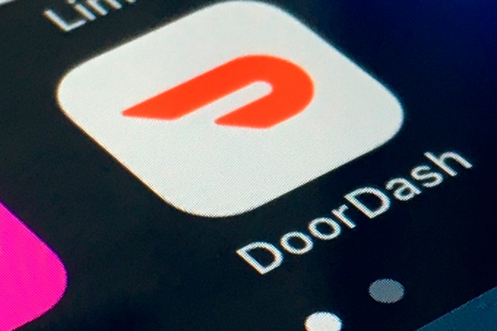 FILE - The DoorDash app is shown on a smartphone on Feb. 27, 2020, in New York.   In 2020, many people took to working remotely in sweatpants, hopped onto an expensive high-tech exercise bike and had their favorite restaurant dish delivered, perhaps by a driver trying to earn an extra buck and hoping not to catch the coronavirus. (AP Photo)
