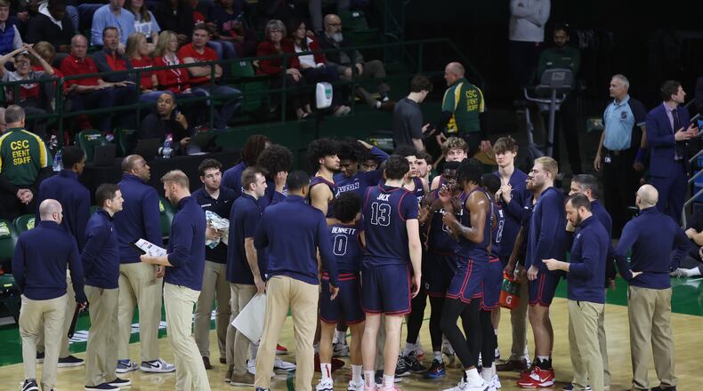 Dayton huddles during a game against George Mason on Wednesday, Feb. 21, 2024, at EagleBank Arena in Fairfax, Va. David Jablonski/Staff