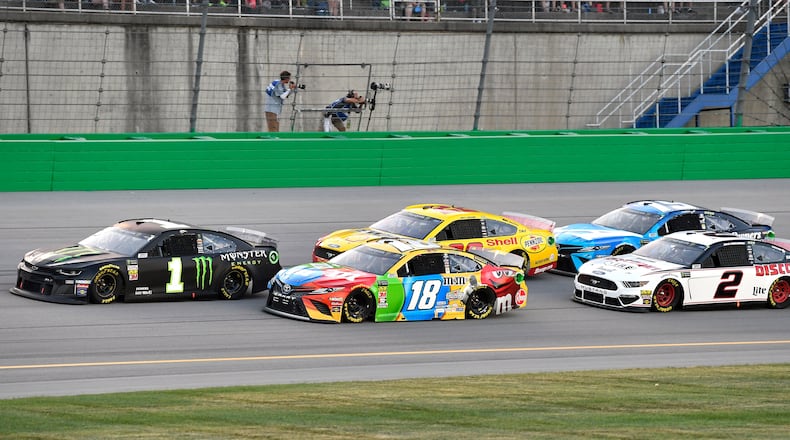 Kurt Busch (1) leads Kyle Busch (18), Joey Logano (22), Brad Keselowski (2) and Martin Truex Jr. (19) following a restart during the NASCAR Cup Series auto race at Kentucky Speedway in Sparta, Ky., Saturday, July 13, 2019. (AP Photo/Timothy D. Easley)