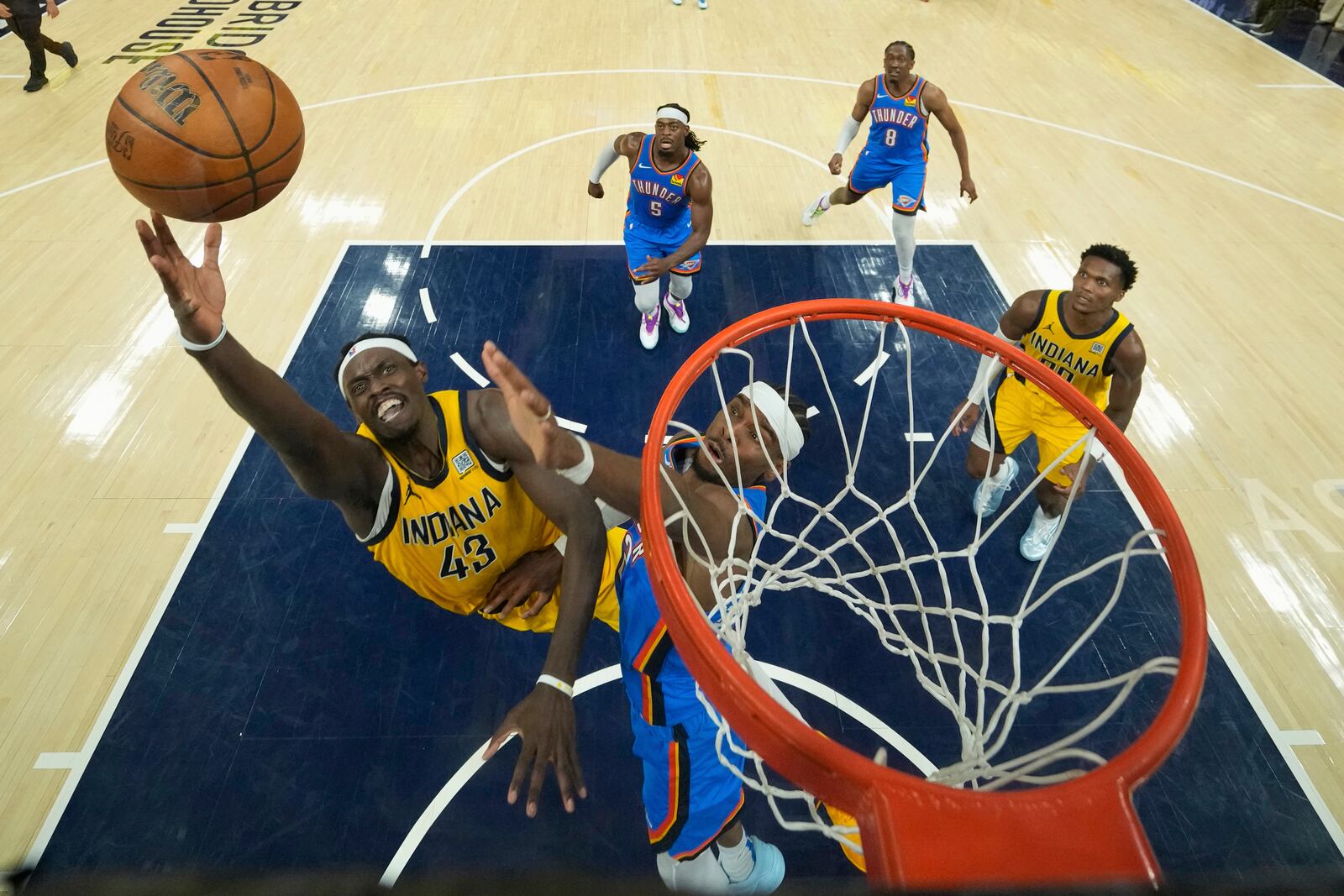 Indiana Pacers forward Pascal Siakam (43) shoots over Oklahoma City Thunder guard Luguentz Dort during the first half of Game 3 of the NBA Finals basketball series, Wednesday, June 11, 2025, in Indianapolis. (AP Photo/Abbie Parr)