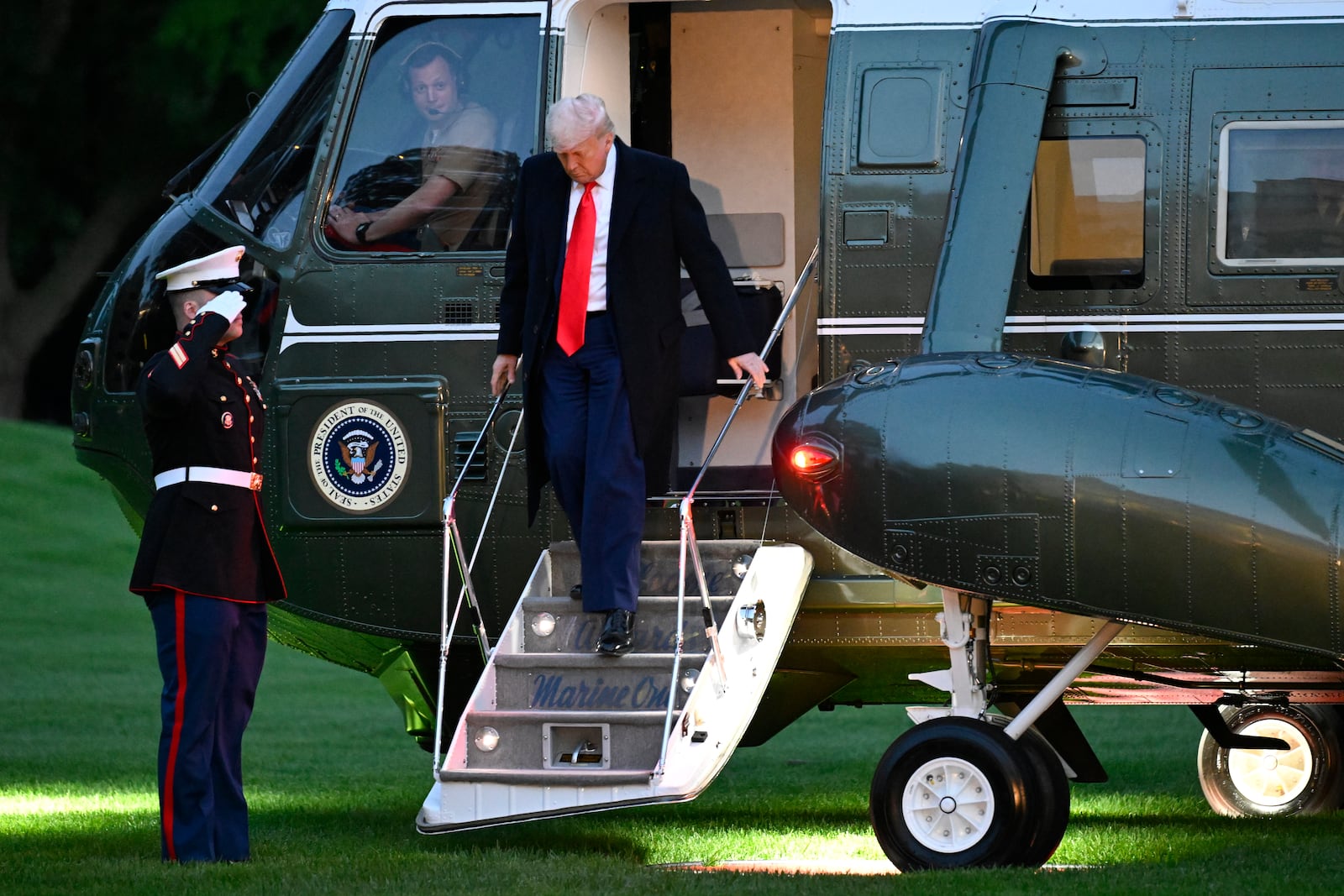 President Donald Trump arrives on the South Lawn of the White House, Thursday, May 22, 2025, in Washington, after attend a crypto dinner at Trump National Golf Club Washington DC. (AP Photo/John McDonnell)