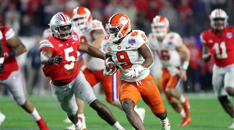 GLENDALE, ARIZONA - DECEMBER 28: Travis Etienne #9 of the Clemson Tigers carries the ball for a 53-yard touchdown reception against the Ohio State Buckeyes in the second half during the College Football Playoff Semifinal at the PlayStation Fiesta Bowl at State Farm Stadium on December 28, 2019 in Glendale, Arizona. (Photo by Matthew Stockman/Getty Images)