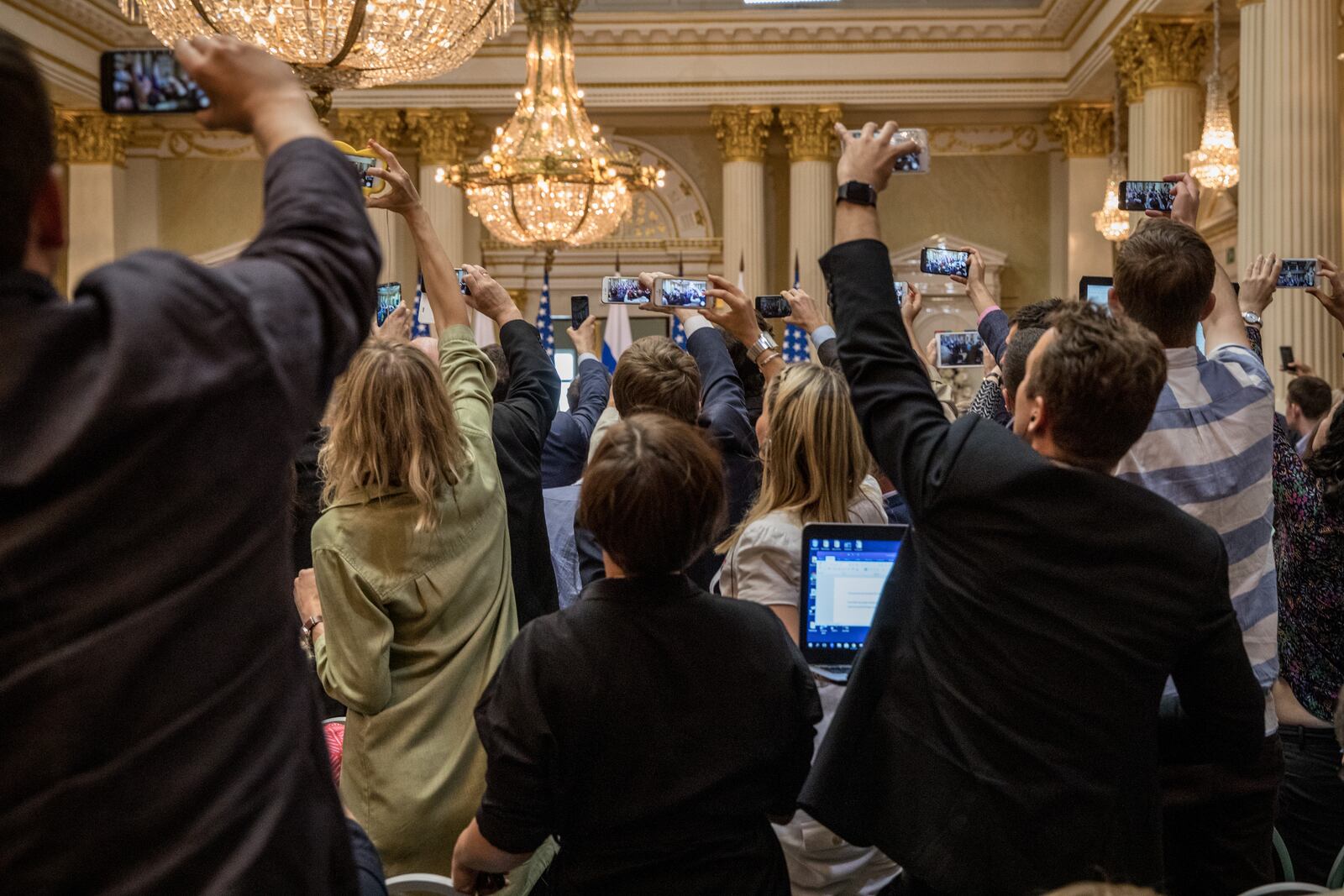 HELSINKI, FINLAND - JULY 16: Members of the U.S and Russian press film as a man is escorted from the room by Finnish Secret service agents ahead of the start of the joint press conference between U.S. President Donald Trump and Russian President Vladimir Putin after their summit on July 16, 2018 in Helsinki, Finland. The two leaders met one-on-one and discussed a range of issues including the 2016 U.S Election collusion.  (Photo by Chris McGrath/Getty Images)