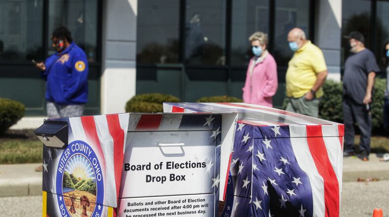 Voters line up at the Butler County Board of Elections on the first day of early voting Tuesday, October 6, 2020 in Hamilton. NICK GRAHAM / STAFF