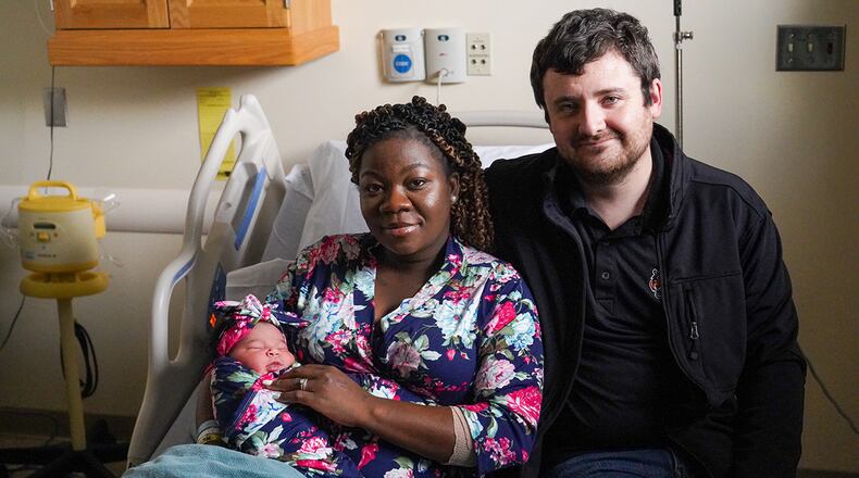 Patience Mantor and Army Spc. Cody Wallace of the Ohio National Guard smile with their newborn, Kalea Izzie Wallace, on Jan. 5 at Wright-Patterson Medical Center. The base hospital’s first newborn of 2022 arrived at 12:13 p.m. Jan. 4. U.S. AIR FORCE PHOTO/KENNETH STILES