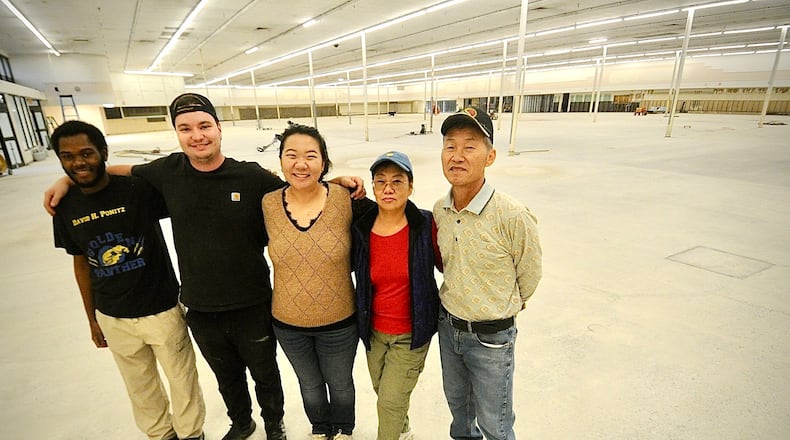 Pandora Beauty Supply was destroyed by a tornado three years ago the owners purchased the old Kroger store on Needmore Road. From left, Malachi Dotson, Jake Luckett, Jean Luckett, Young Joo and Sang Joo. The business is set to open in January. MARSHALL GORBY \STAFF