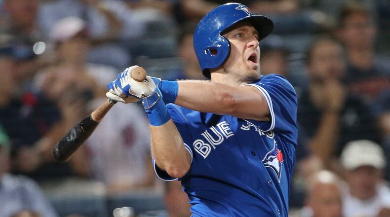 Toronto Blue Jays second baseman Cliff Pennington follows through on a three-run home run during the fourth inning of a baseball game against the Atlanta Braves on Thursday, Sept. 17, 2015, in Atlanta. (AP Photo/John Bazemore)