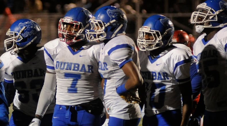 Dunbar standouts Tavion Thomas (7) and Jo-Jo Scates were ousted by Trotwood-Madison, 64-26 at Butler on Friday. MARC PENDLETON / STAFF