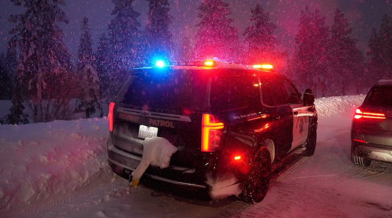 A California Highway Patrol vehicle is parked along a road during a snow storm Wednesday, Feb. 18, 2026, in Placer County, Calf. (AP Photo/Godofredo A. Vásquez)