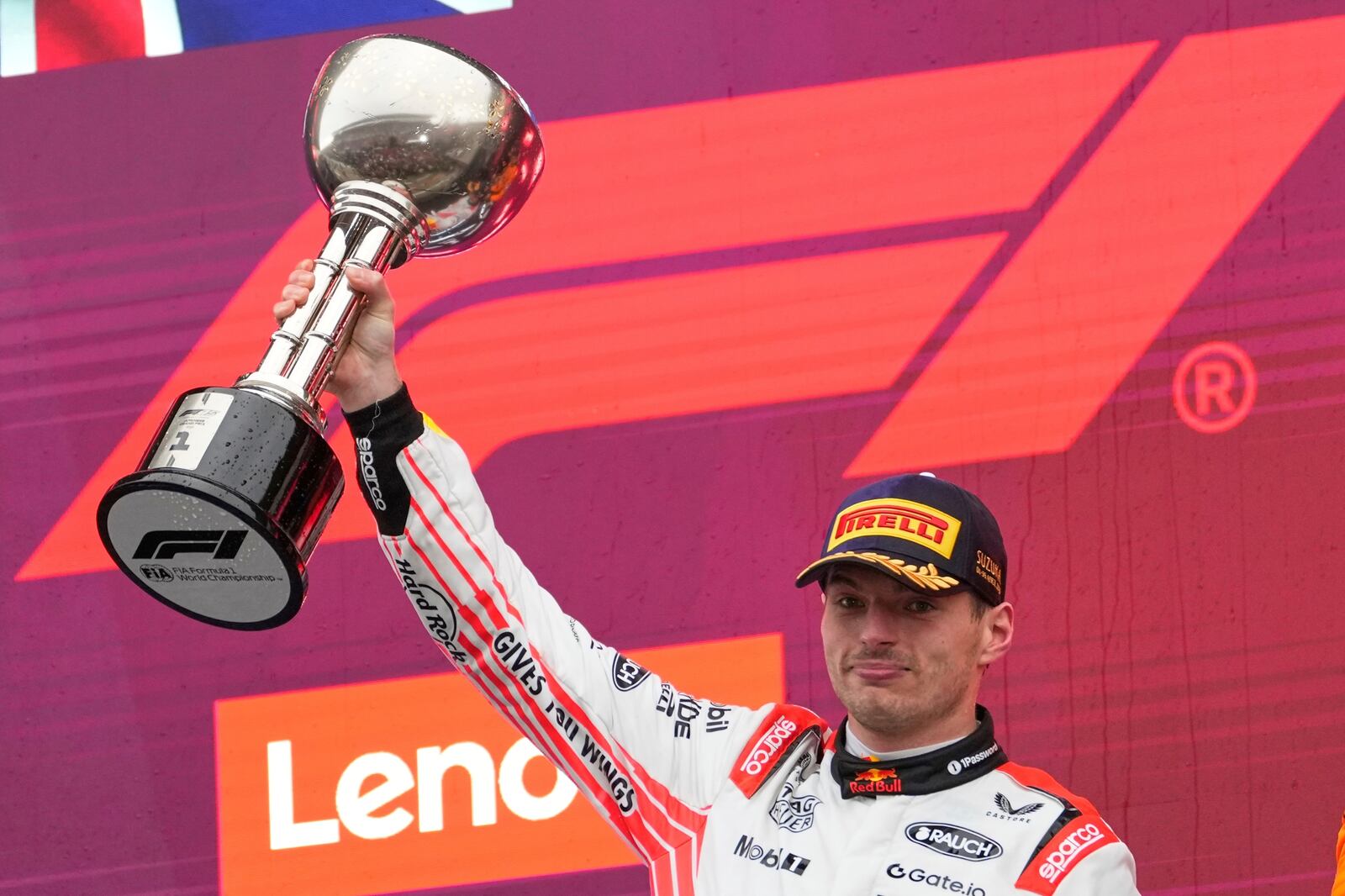 Red Bull driver Max Verstappen of the Netherlands celebrates with his trophy on the podium after the Japanese Formula One Grand Prix at the Suzuka Circuit in Suzuka, central Japan, Sunday, April 6, 2025. (AP Photo/Shuji Kajiyama)