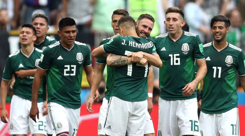 MOSCOW, RUSSIA - JUNE 17: Hirving Lozano of Mexico celebrates with team mates of Mexico after scoring his team's first goal during the 2018 FIFA World Cup Russia group F match between Germany and Mexico at Luzhniki Stadium on June 17, 2018 in Moscow, Russia. (Photo by Clive Rose/Getty Images)