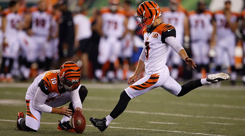 Cincinnati Bengals kicker Jake Elliott (3) kicks an extra point alongside punter Kevin Huber (10) in the second half of a preseason NFL football game against the Tampa Bay Buccaneers, Friday, Aug. 11, 2017, in Cincinnati. (AP Photo/Gary Landers)