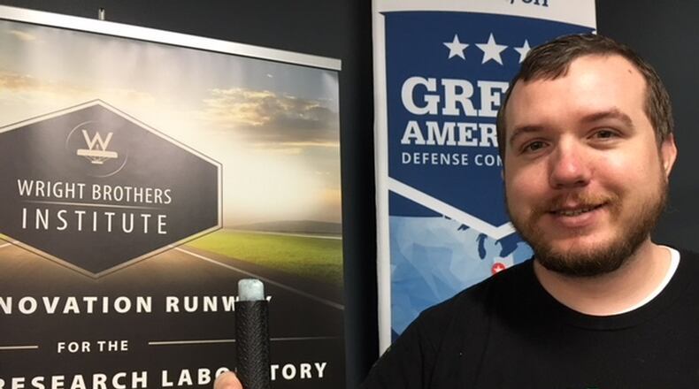 Nicholas Ripplinger, president of Battle Sight Technologies LLC, holding the implement that can leave writing and marks visible only to warfighters and first-responders who have certain night vision goggles. Battle Sight last week won a Soin Award for Innovation and is already bringing in revenue from customers who value the company’s technology. THOMAS GNAU/STAFF