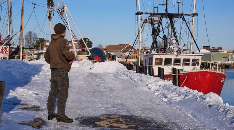 Gryphon Orfanos, who in the past worked on the fishing vessel "Lily Jean", stands on the pier of the homeport of the fishing boat that went missing with seven onboard, Monday, Feb. 2, 2026, in Gloucester, Mass. (AP Photo/Charles Krupa)