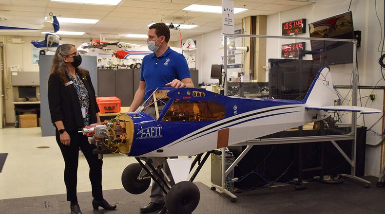 Dr. Wendy Walsh, Air Education and Training Command’s chief learning officer, and Dr. Robert Leishman, Autonomy and Navigation Technology Center director, discuss the facility’s unmanned aerial vehicle test bed used to fly various alternative-navigation experiments during her visit Feb. 8. U.S. AIR FORCE PHOTO/KATIE SCOTT