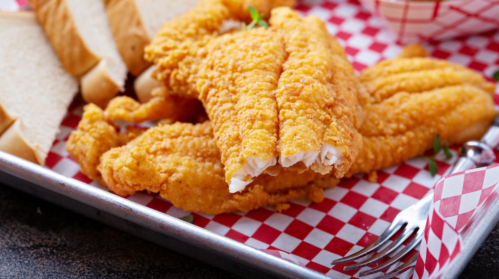 Shown in this photo to promote fish fry season is southern fried fish with toast, buttermilk breaded cod or catfish. ISTOCK