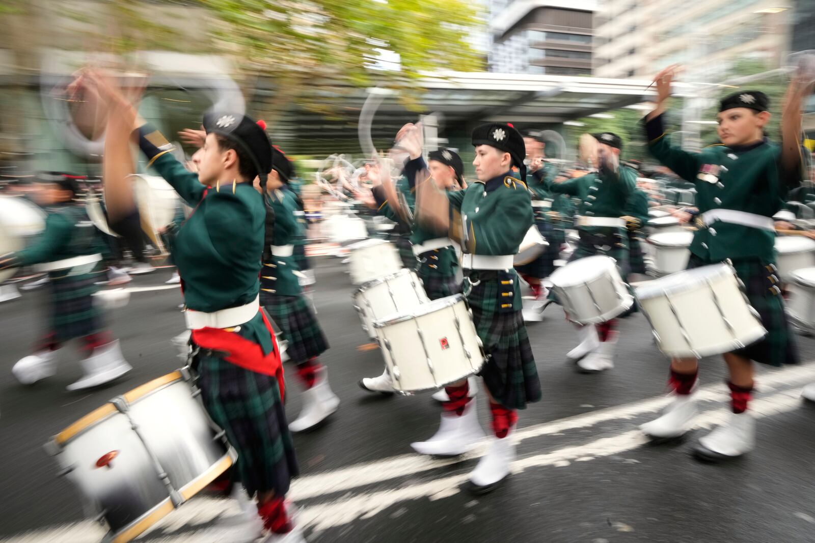 A band marches by as thousands of people line the street to pay tribute to their war dead on Anzac Day in Sydney, Australia, Friday, April 25, 2025. (AP Photo/Rick Rycroft)