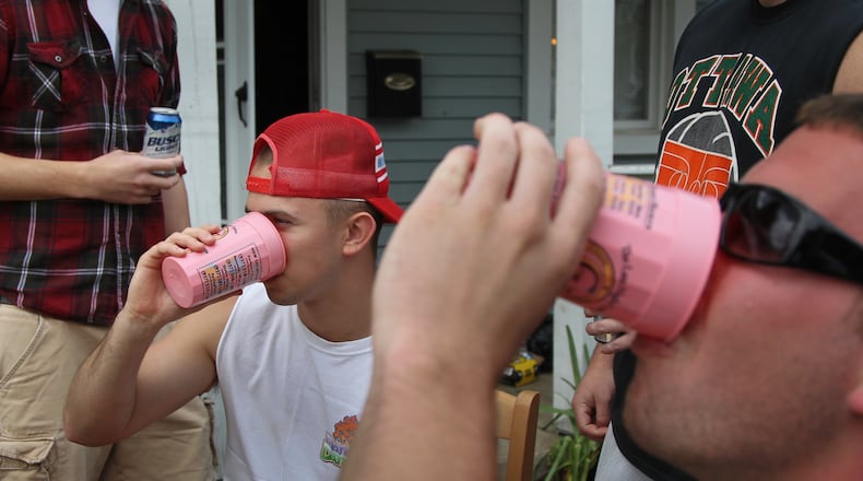 University of Dayton students play drinking games in front of a house in the UD student neighborhood. CHRIS STEWART / STAFF