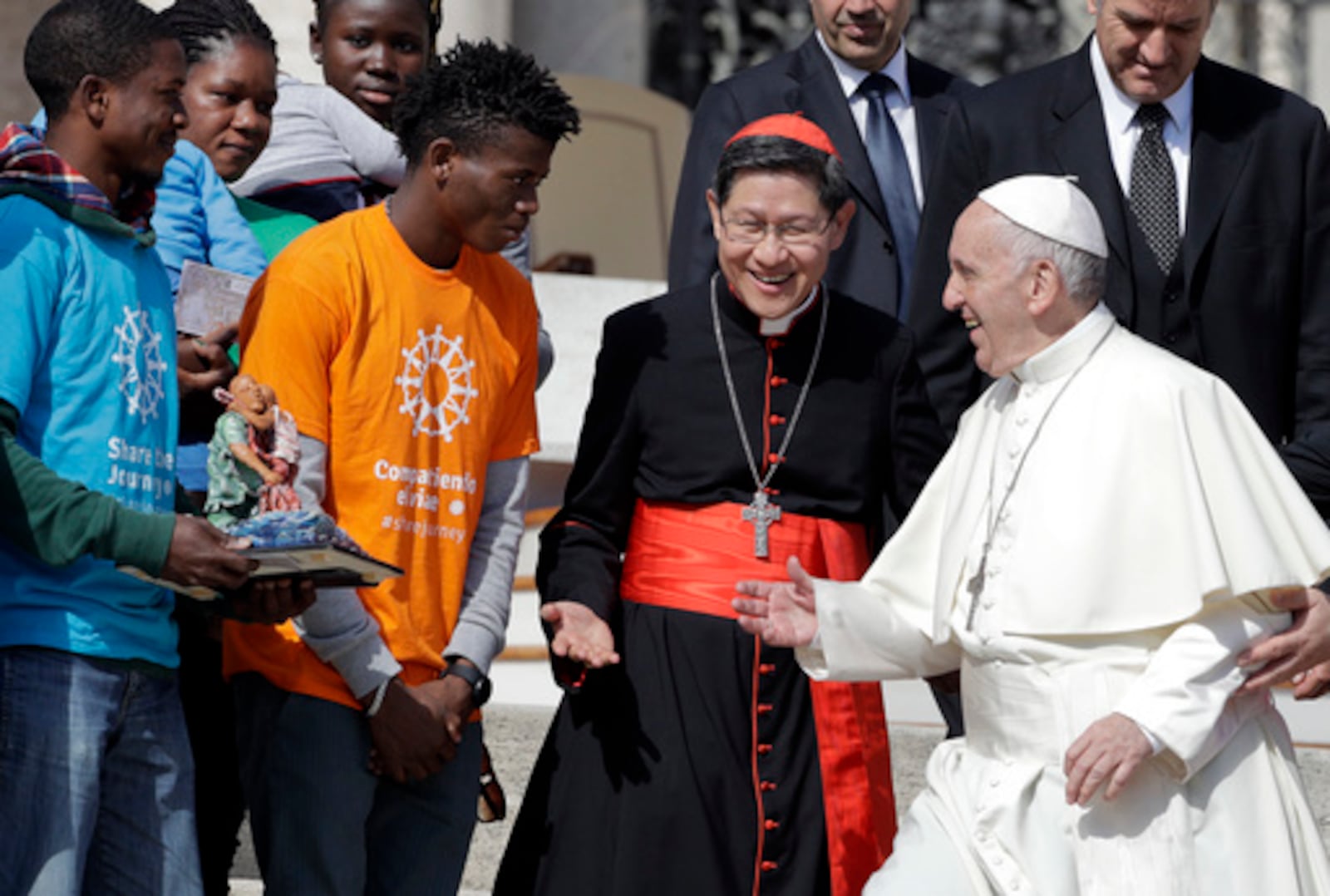 FILE - Pope Francis greets Cardinal Luis Antonio Tagle, archbishop of Manila, second from right, and group of migrants, during his weekly general audience, at the Vatican, Wednesday, Sept. 27, 2017. (AP Photo/Andrew Medichini, File)