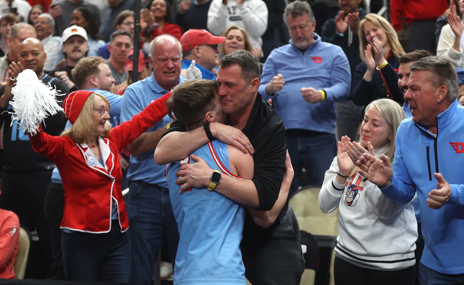 Dayton's Jordan Derkack hugs his dad Gene after a victory against Saint Louis in the semifinals of the Atlantic 10 Conference tournament on Saturday, March 14, 2026, at PPG Paints Arena in Pittsburgh. David Jablonski/Staff