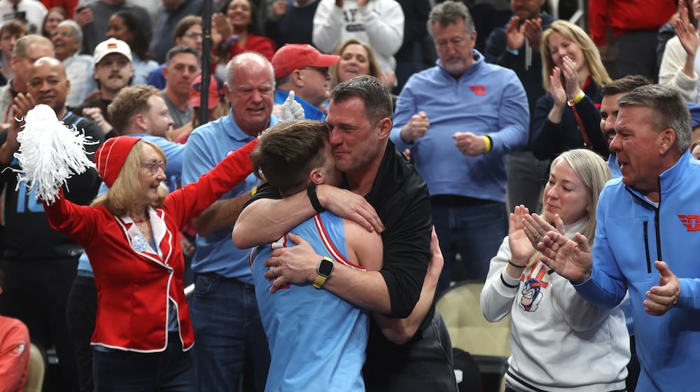 Dayton's Jordan Derkack hugs his dad Gene after a victory against Saint Louis in the semifinals of the Atlantic 10 Conference tournament on Saturday, March 14, 2026, at PPG Paints Arena in Pittsburgh. David Jablonski/Staff