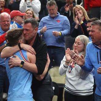 Dayton's Jordan Derkack hugs his dad Gene after a victory against Saint Louis in the semifinals of the Atlantic 10 Conference tournament on Saturday, March 14, 2026, at PPG Paints Arena in Pittsburgh. David Jablonski/Staff