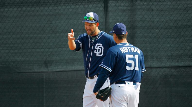 San Diego Padres pitcher Tom Wilhelmsen, who became a bartender during his seven seasons away from baseball, works with Trevor Hoffman (51) during a spring training practice in Peoria, Ariz., on February 21, 2018. (K.C. Alfred/San Diego Union-Tribune)