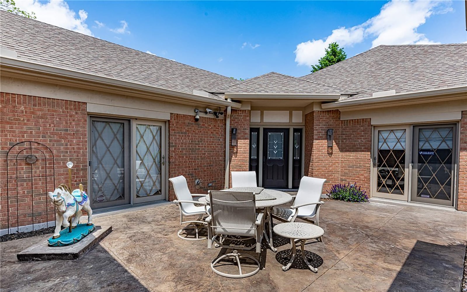 The front of the home has a private courtyard with a wrought iron gate and three doors that open from different areas of the interior of the home. CONTRIBUTED