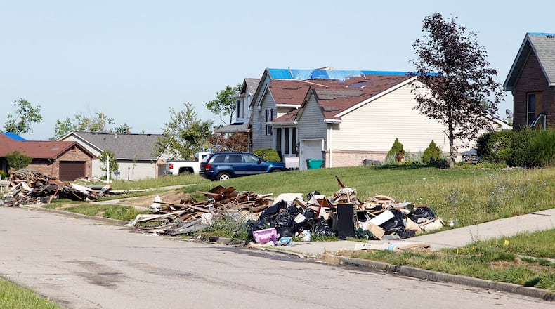 Damaged home debris along Butterfield Drive in Beavercreek nearly two months after the Memorial Day tornadoes ripped through the area in 2019.  TY GREENLEES / STAFF