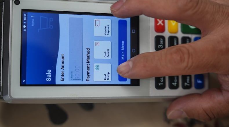 A shopper makes a purchase with food stamps on Monday, Oct. 27, 2025, in Los Angeles. (AP Photo/Damian Dovarganes)