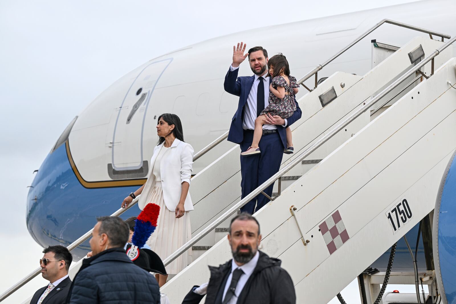 Vice President JD Vance, carrying their daughter Mirabel and Second Lady Usha Vance disembark Air Force Two upon arriving at G.B. Pastine–Rome Ciampino Airport, Friday April 18, 2025. (Kenny Holston/The New York Times via AP, Pool)