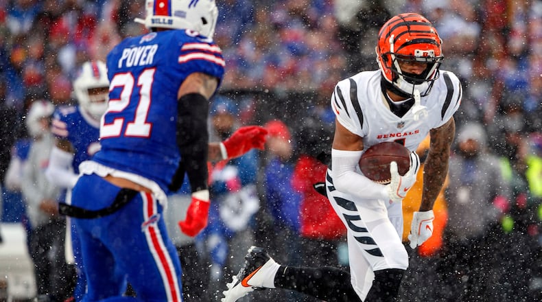 Cincinnati Bengals wide receiver Ja'Marr Chase, right, runs for a touchdown after a catch during an NFL divisional round playoff football game against the Buffalo Bills, Jan. 22, 2023, in Orchard Park, NY. (AP Photo/Matt Durisko, File)