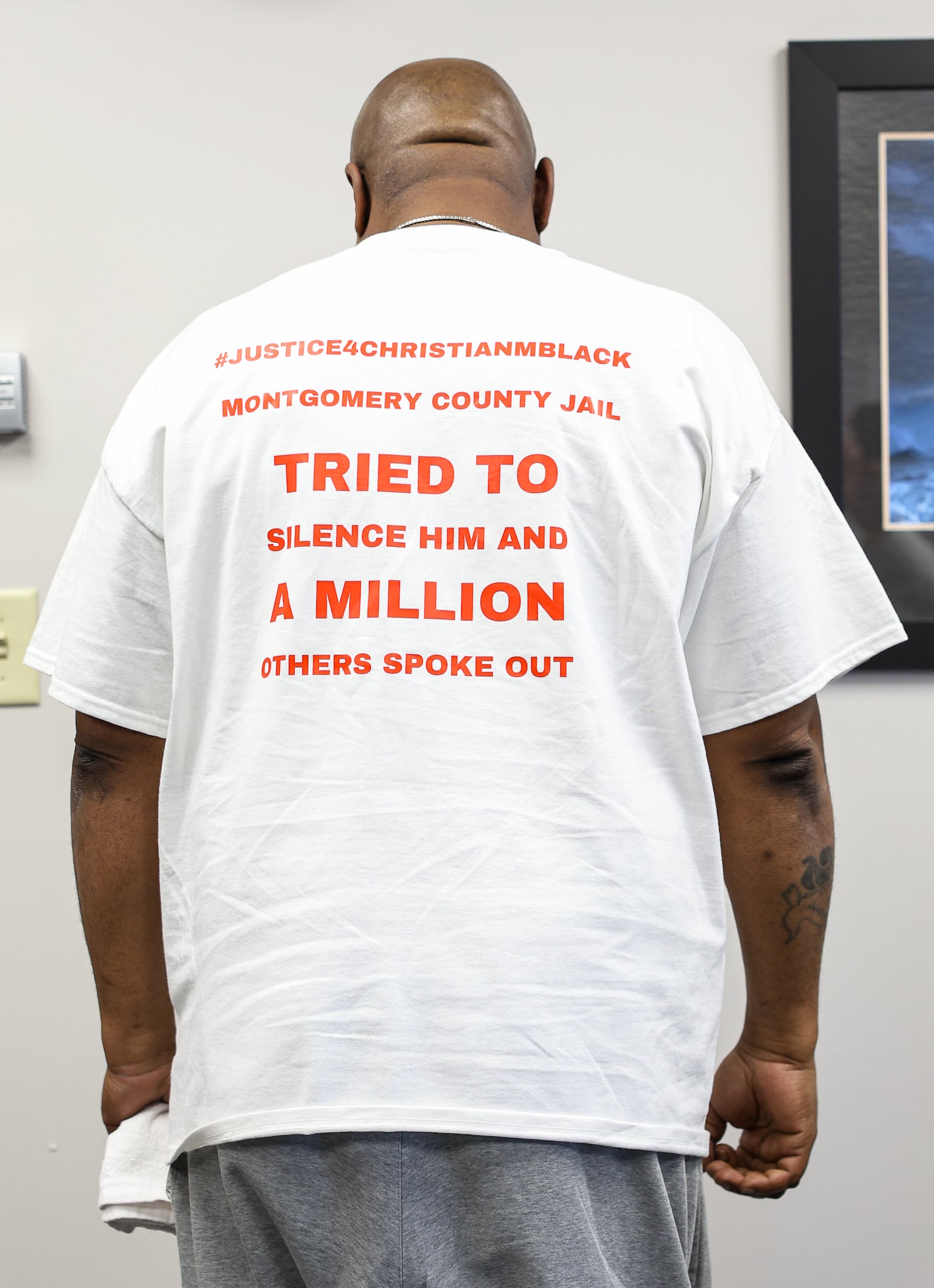 Kenya Black poses in a shirt family members of Christian Black wore during a news conference on Tuesday at the offices of Wright and Schulte in downtown Dayton. BRYANT BILLING / STAFF