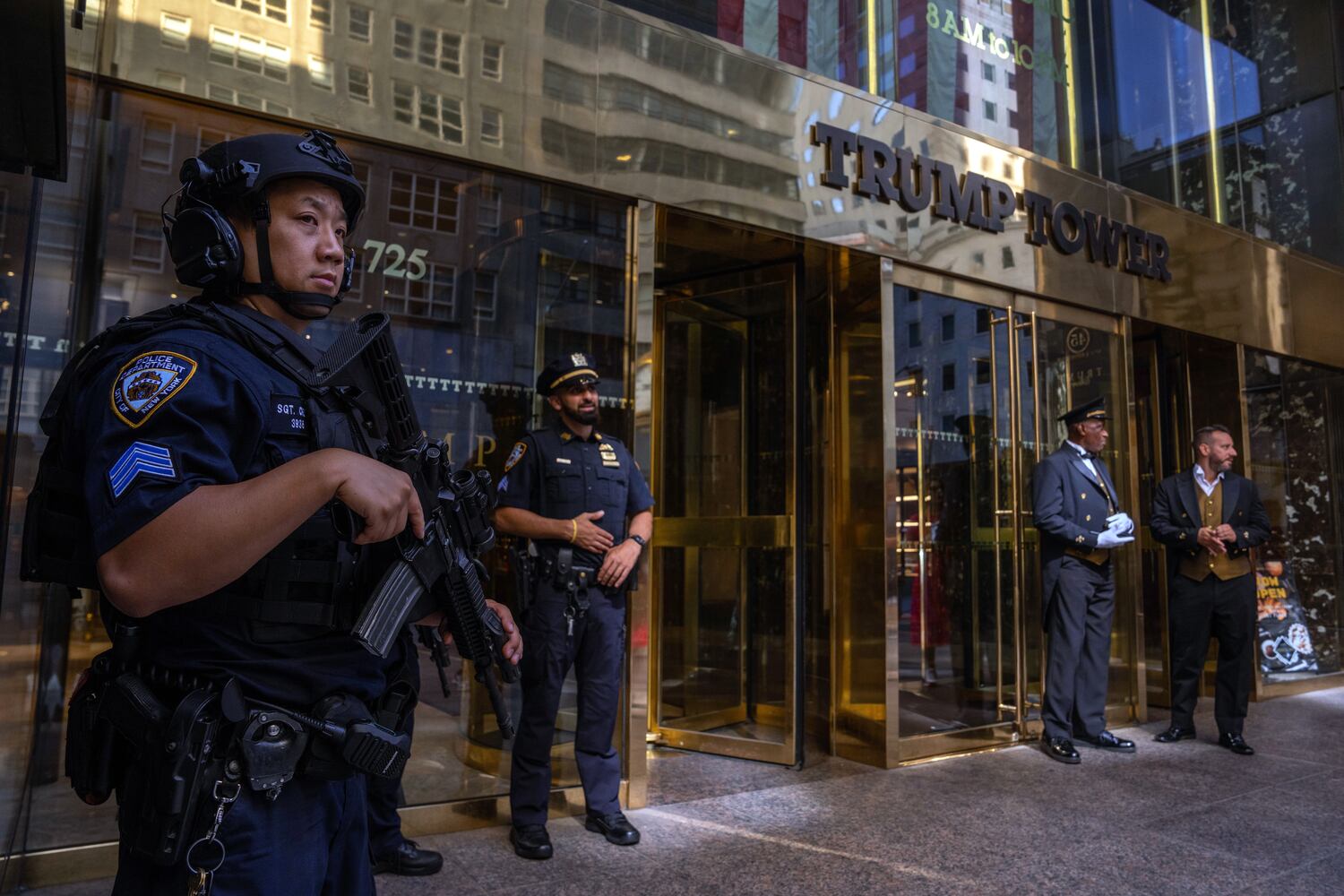 Police officers stand guard outside Trump Tower in midtown Manhattan on Sunday morning, July 14, 2024, one day after former President Donald Trump was shot while speaking at a campaign rally in Butler, Pa.  (Adam Gray/The New York Times)